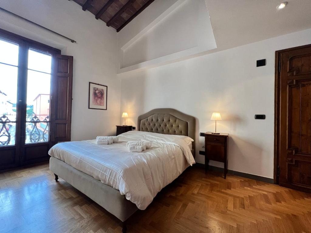 a bedroom with a bed with two towels on it at Baroni Cortelli Apartments Firenze in Florence