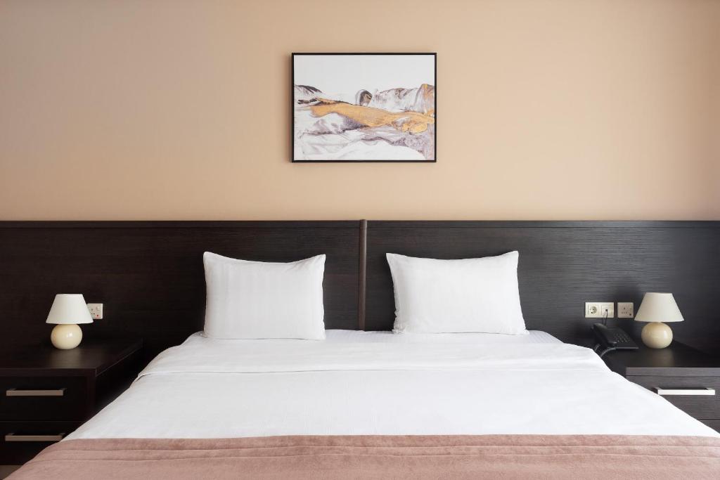 Postel nebo postele na pokoji v ubytování Sephia Hotel