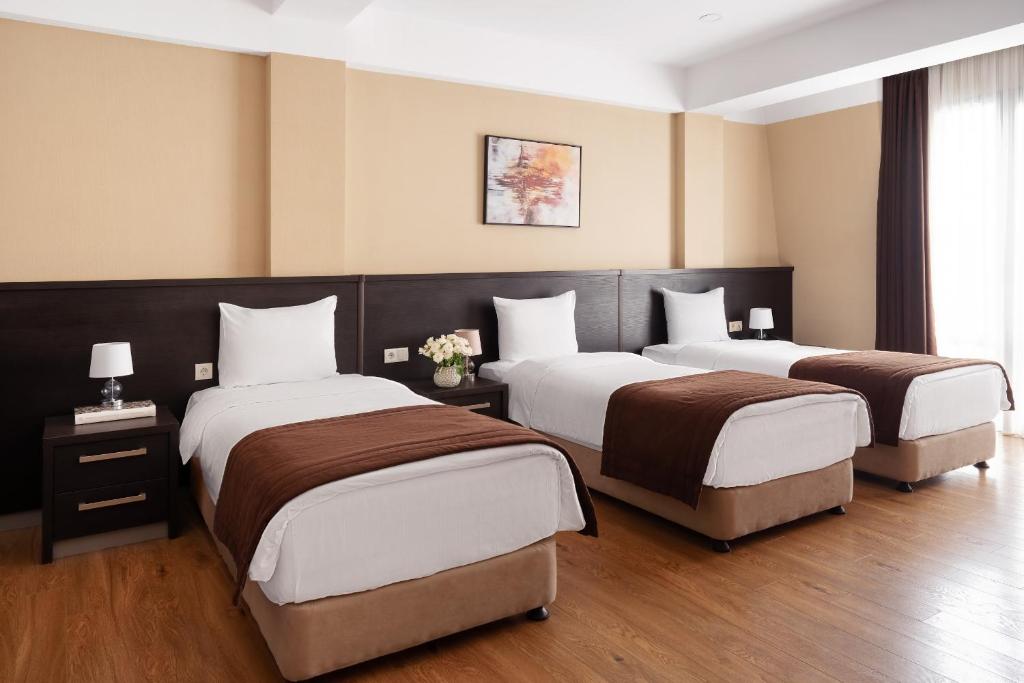 Postel nebo postele na pokoji v ubytování Sephia Hotel