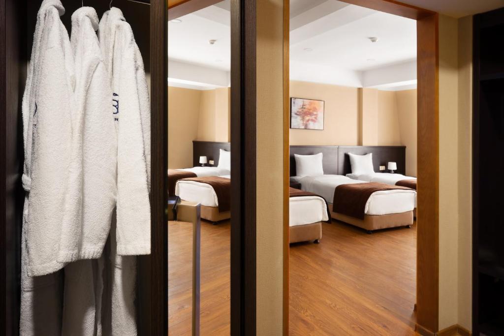 Postel nebo postele na pokoji v ubytování Sephia Hotel