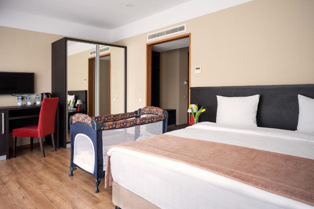 Postel nebo postele na pokoji v ubytování Sephia Hotel