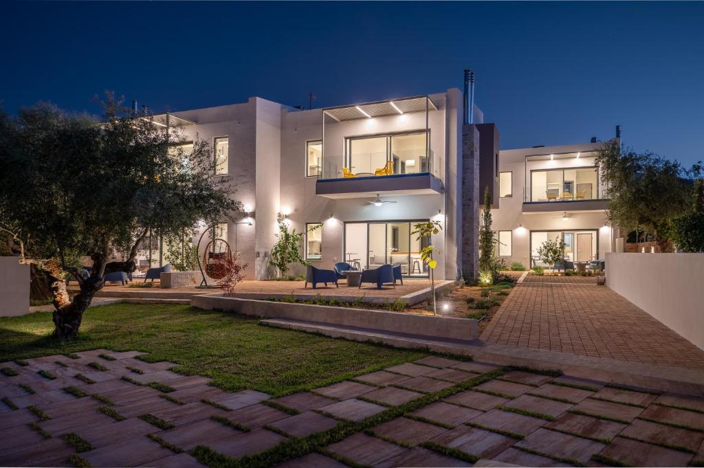 a large white house at night with a patio at VUAR SUITES in Petalidi