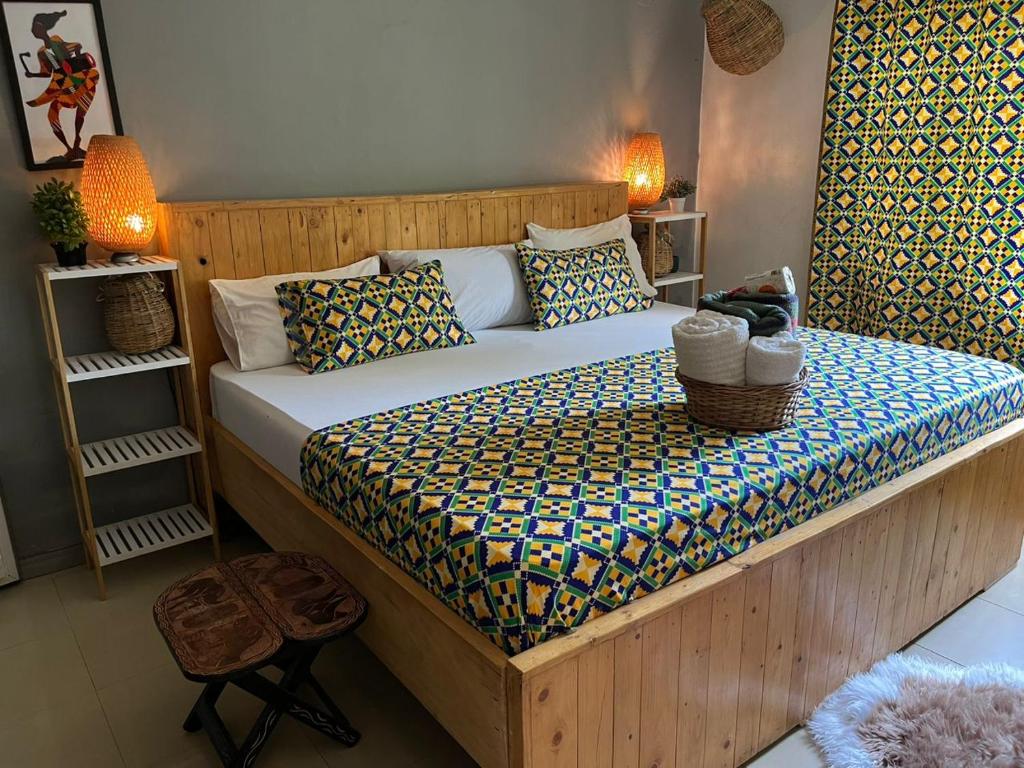 a bedroom with a large bed in a room at African Treasure Beach Resort in Kokrobite