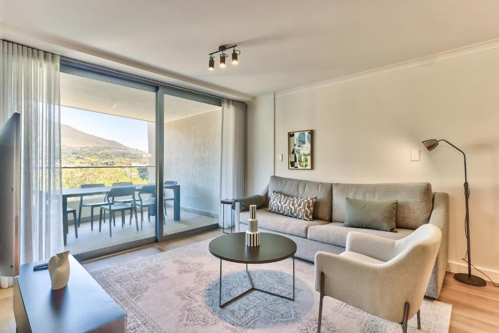 a living room with a couch and a table at 636 Newlands Peak Luxury Apartment in Cape Town