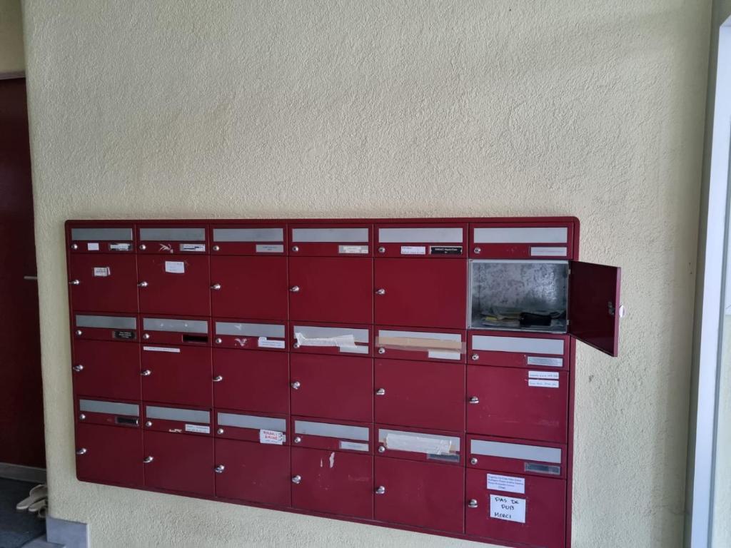 a red metal lockers are on a wall at Joli Studio in La Chaux-de-Fonds