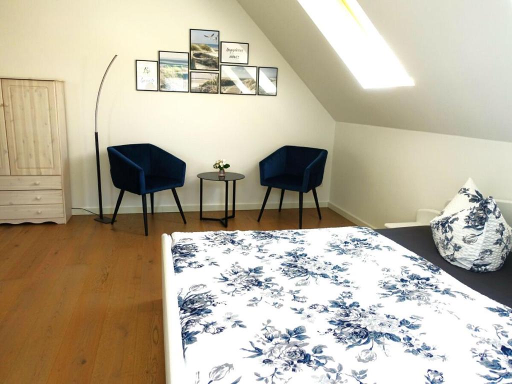 um quarto com duas cadeiras azuis e uma cama em Ferienhaus Melody em Ralswiek