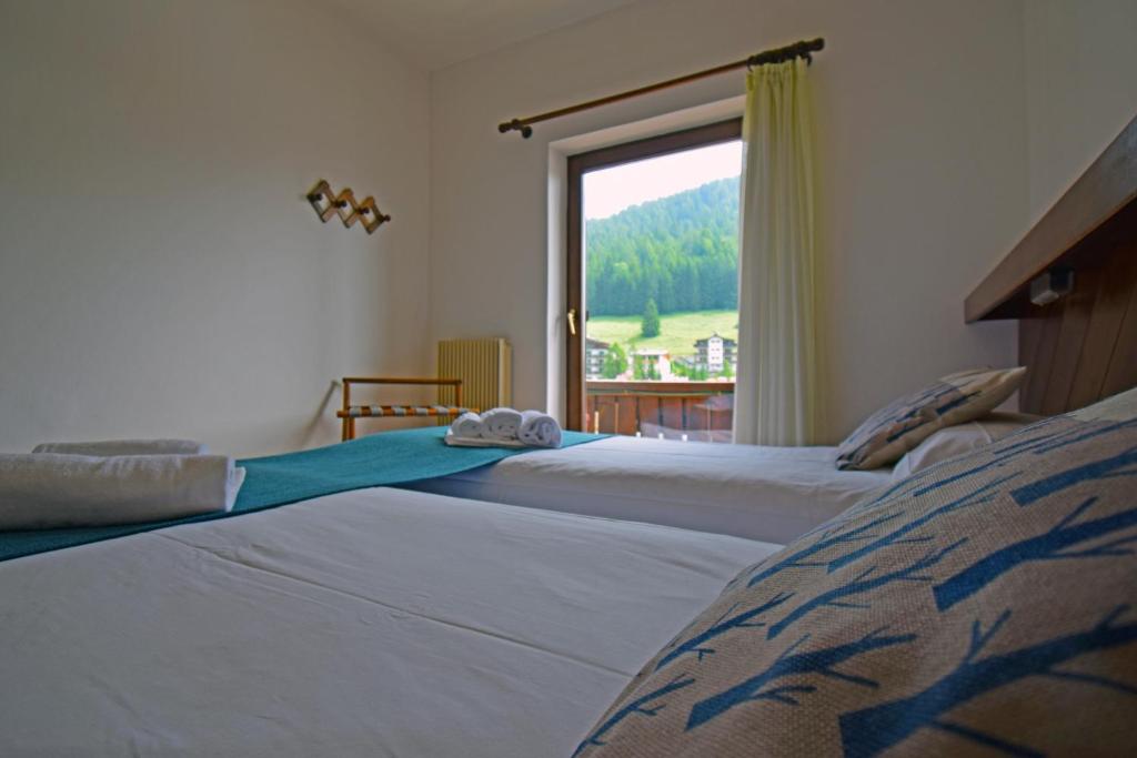 Postel nebo postele na pokoji v ubytování Hotel Comelico