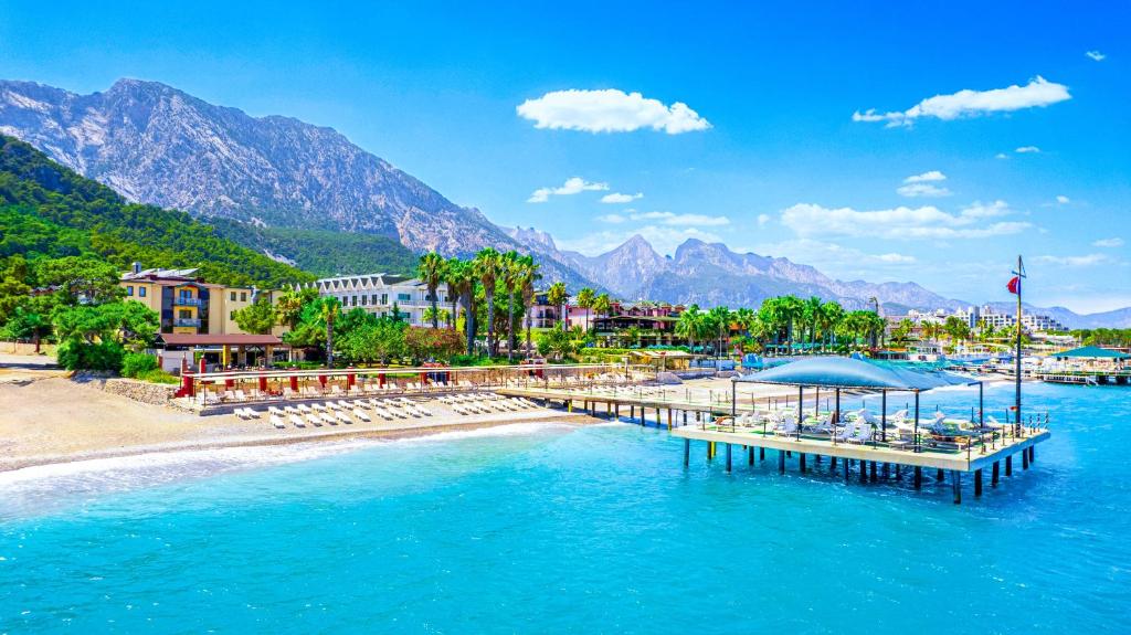 a dock in the water next to a beach at Hotel Sumela Garden - All Inclusive in Beldibi