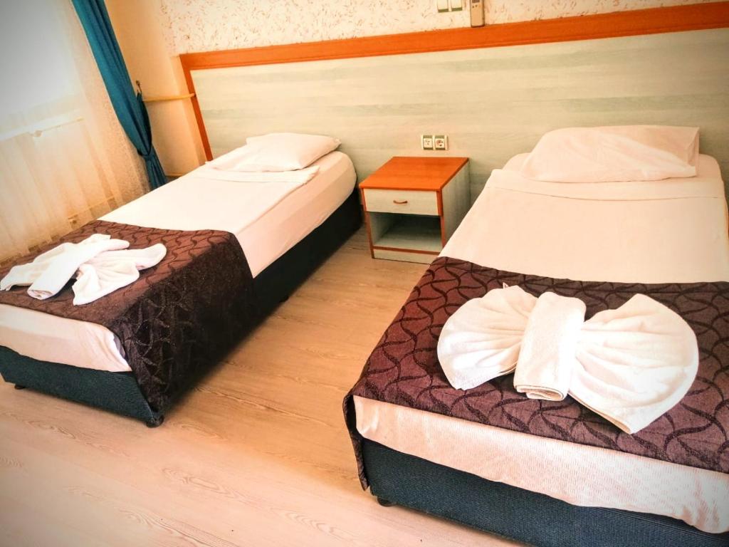 Postel nebo postele na pokoji v ubytování Uyum Hotel