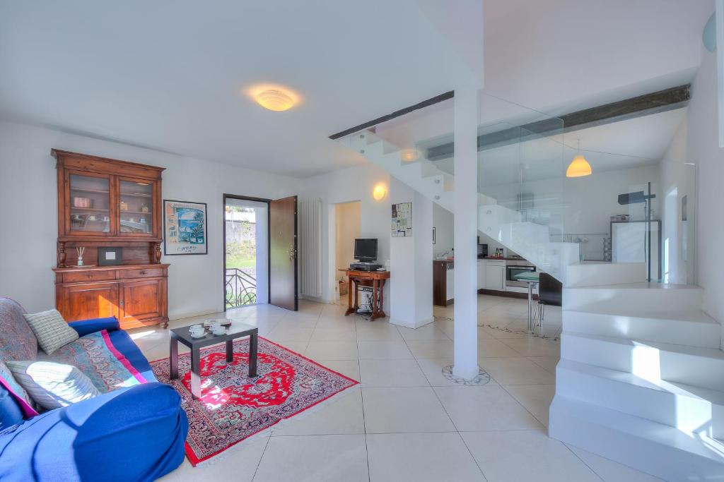 uma sala de estar com um sofá azul e uma escada em Franklin House - Happy Rentals em Lugano