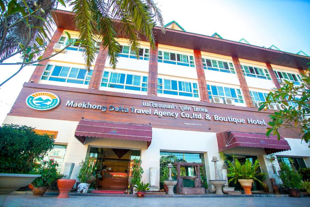 a building with a sign on the front of it at Maekhong Delta Boutique Hotel in Mae Sai