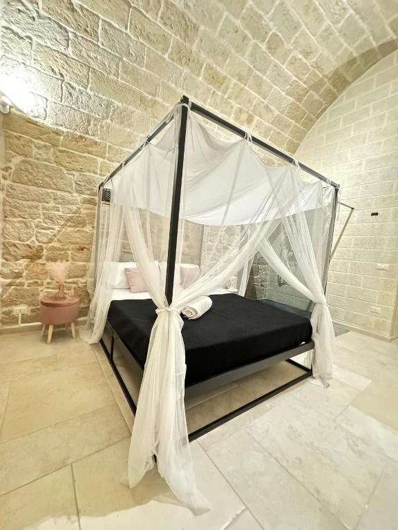 Postel nebo postele na pokoji v ubytování Amalè Suite 25 Medioevo Design