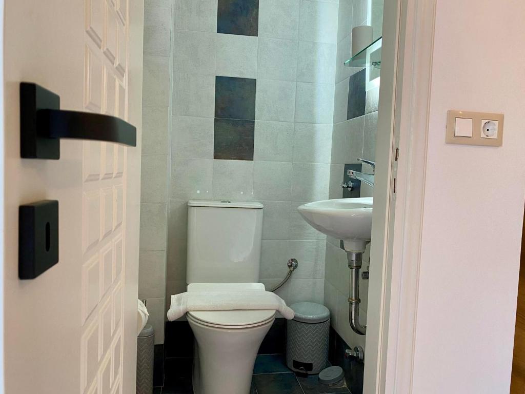 a bathroom with a toilet and a sink at PORTA HOME modern and hospitable in Naxos Chora