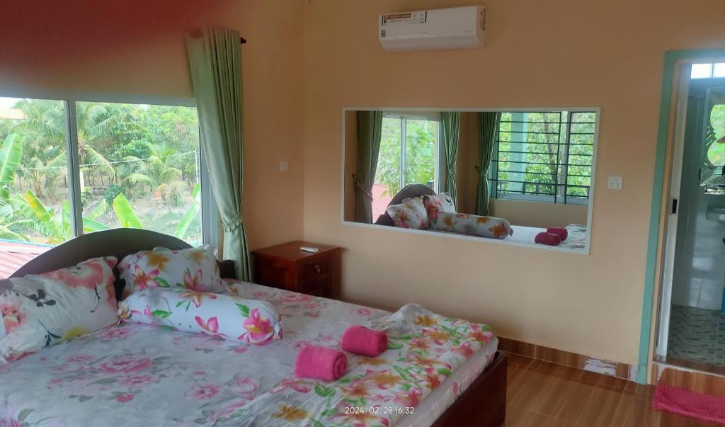 a bedroom with a bed and a large mirror at Jasmine Resort Kampot in Kampot