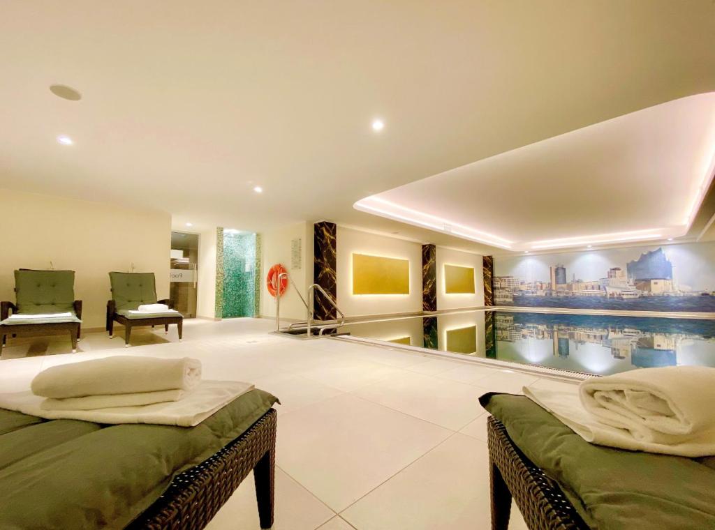a room with two beds and a pool at Courtyard by Marriott Hamburg Airport in Hamburg