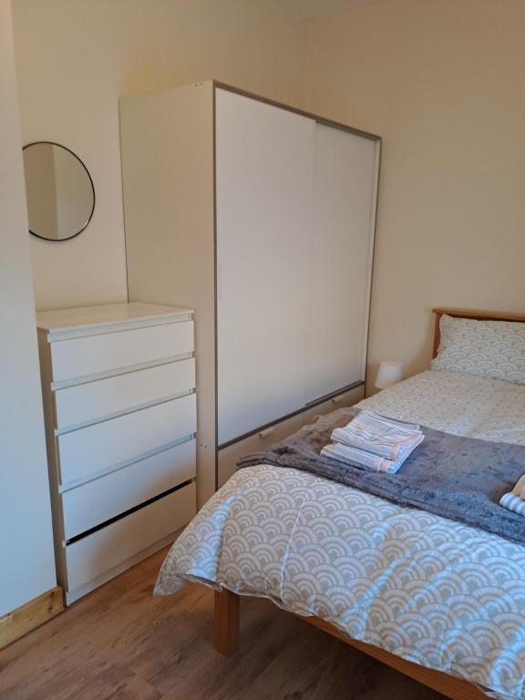 a bedroom with a large bed and a dresser at Drogheda Townhouse in Drogheda