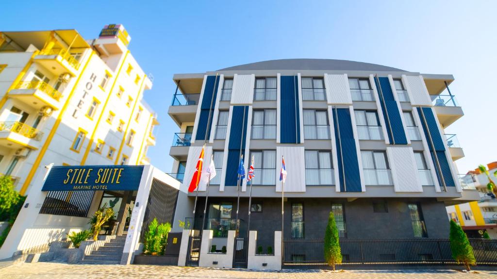 a building with flags in front of it at Stile Suite Marine Hotel in Antalya