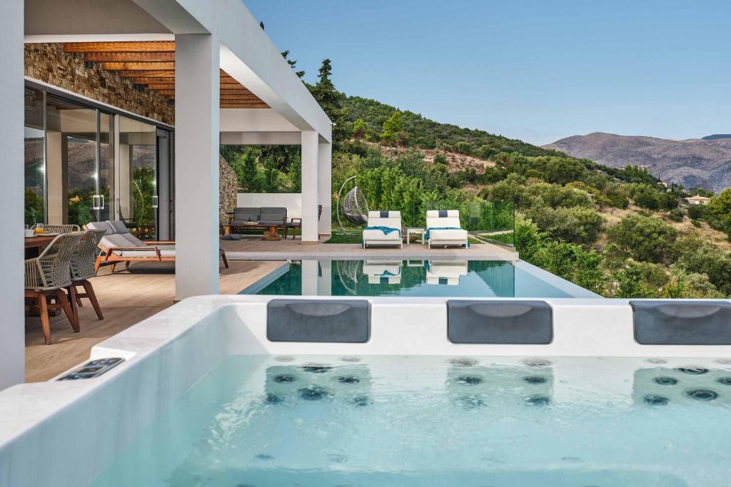 a house with a swimming pool and a patio at Alkyonides Plumage in Marathias