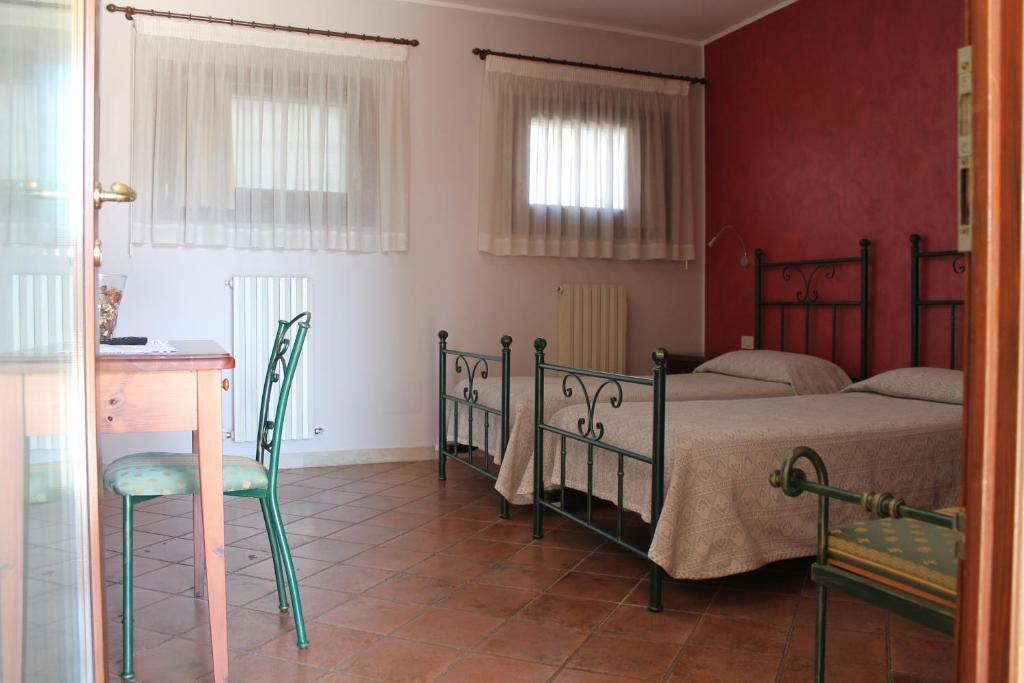 Postel nebo postele na pokoji v ubytování Agriturismo San Bartolomeo