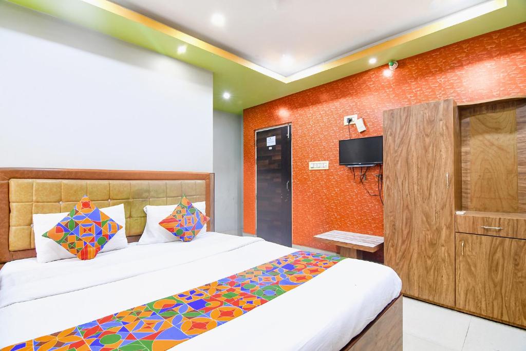 a hotel room with a bed and a tv at FabHotel Stay Inn II in kolkata
