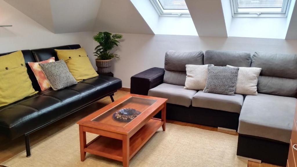 a living room with a leather couch and a coffee table at REY AURELIO 2 in Cangas de Onís