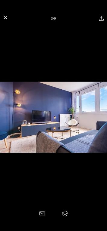 a living room with a bed and a living room with a couch at Superbe appartement Paris Sud: terrasse,parking in Évry-les-Châteaux