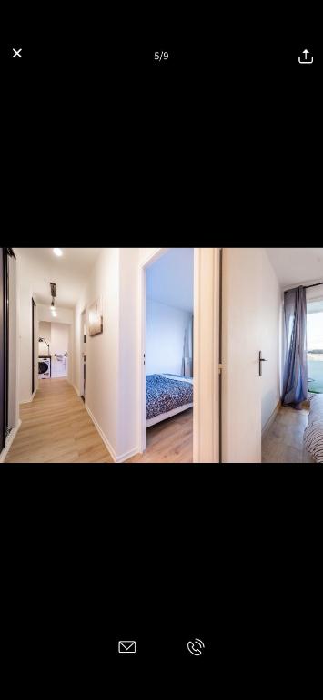 a picture of a room with a bed and a hallway at Superbe appartement Paris Sud: terrasse,parking in Évry-les-Châteaux