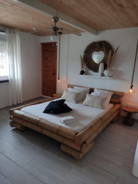 a bedroom with a large bed with a head board at Finca Rayo del Sol in Alhaurín el Grande