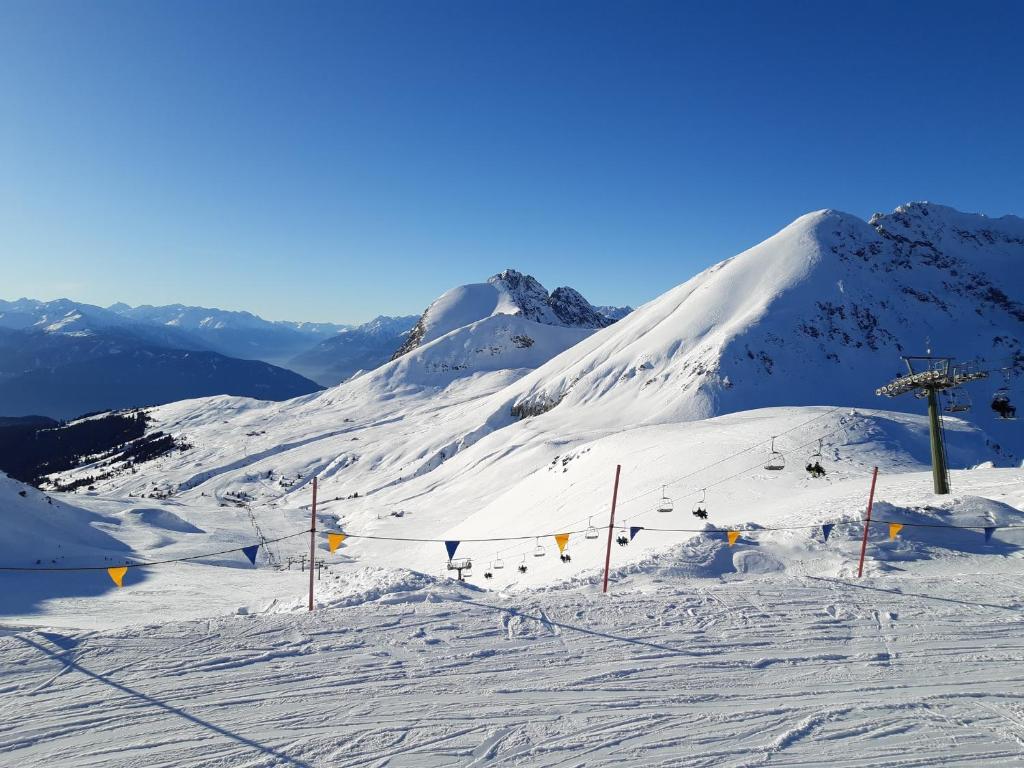 a snow covered mountain with a ski lift on it at Penthouse&Wellness L'Abete in Gargazzone