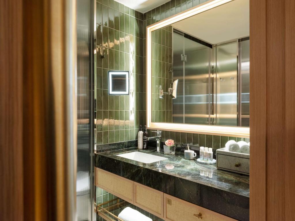 a bathroom with a sink and a mirror at Island Shangri-La, Hong Kong in Hong Kong