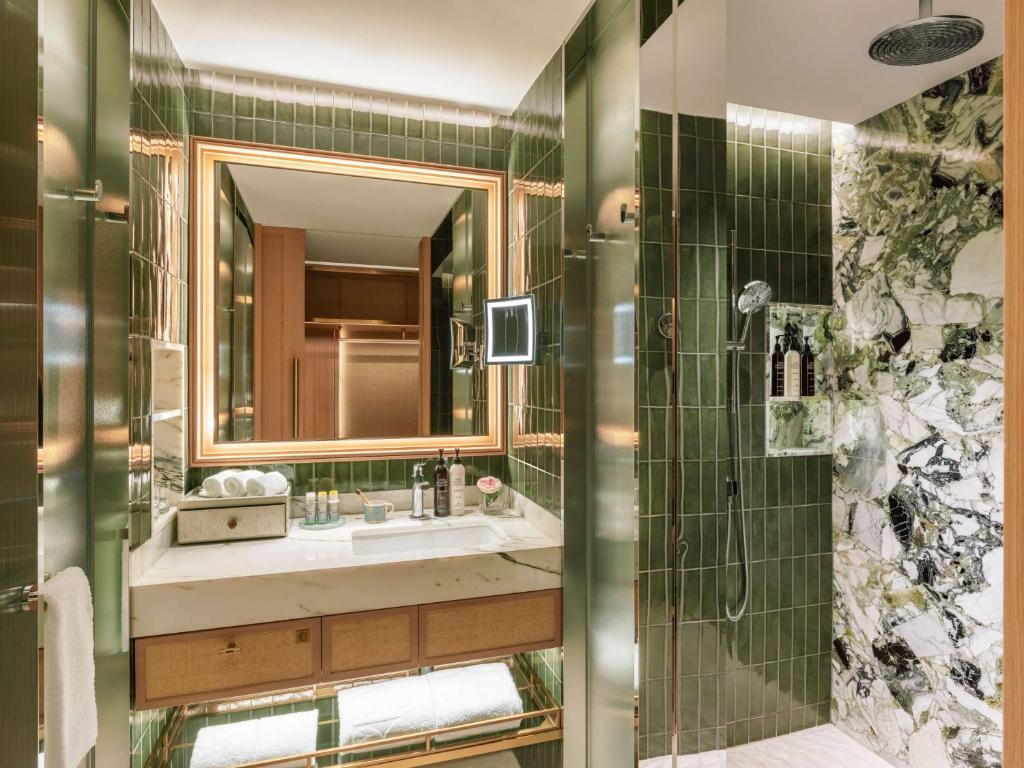 a bathroom with a sink and a shower at Island Shangri-La, Hong Kong in Hong Kong