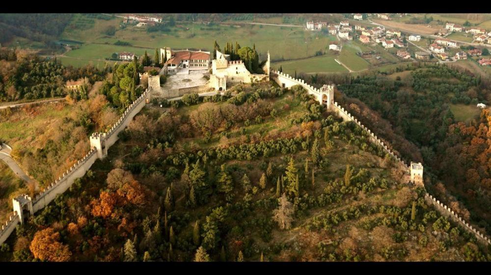 a castle on top of a hill with trees at “Un Luogo Magico” in Marostica