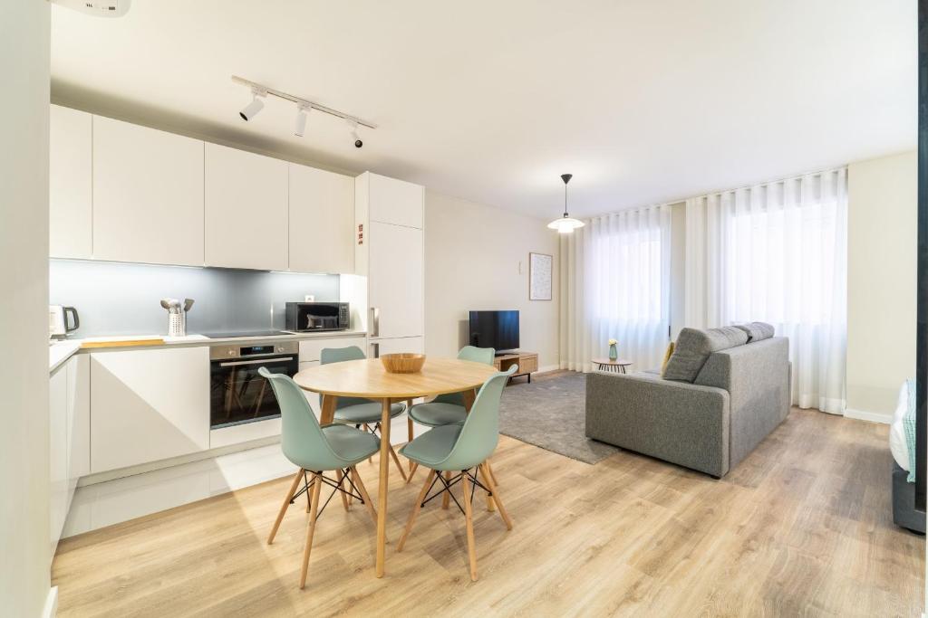 una cucina e un soggiorno con tavolo e sedie di On The Square Studio - City Center by House and People a Braga