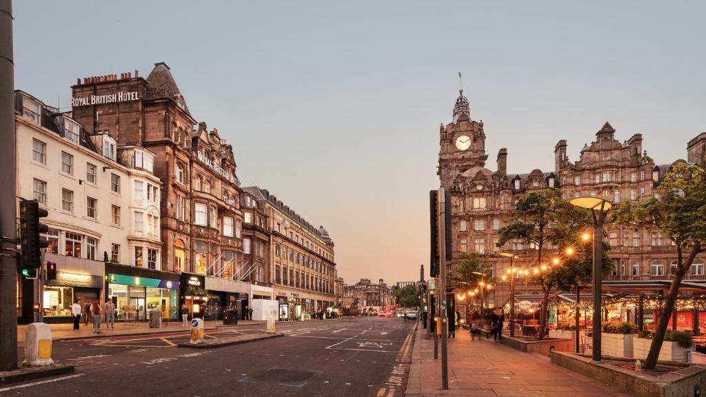 a city street with a clock tower in the distance at Hotel Indigo - Edinburgh - Princes Street by IHG in Edinburgh