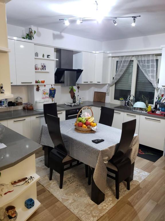 a kitchen with a table with a bowl of fruit on it at 2 bedroom duplex Durrës in Durrës