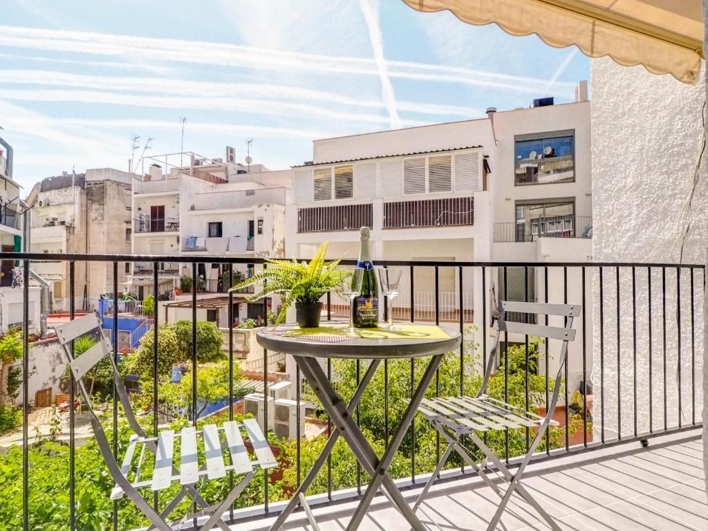 a patio with a table and chairs on a balcony at Espalter Onyx by Hello Homes Sitges in Sitges