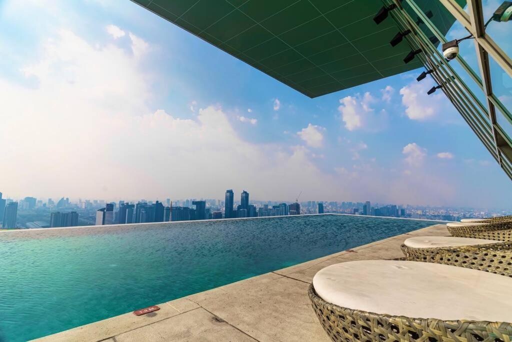 a pool with chairs and a view of a city at Luxury 2 Bedrooms Condo Checkin 24h Infinity Pool 360 in Bangkok