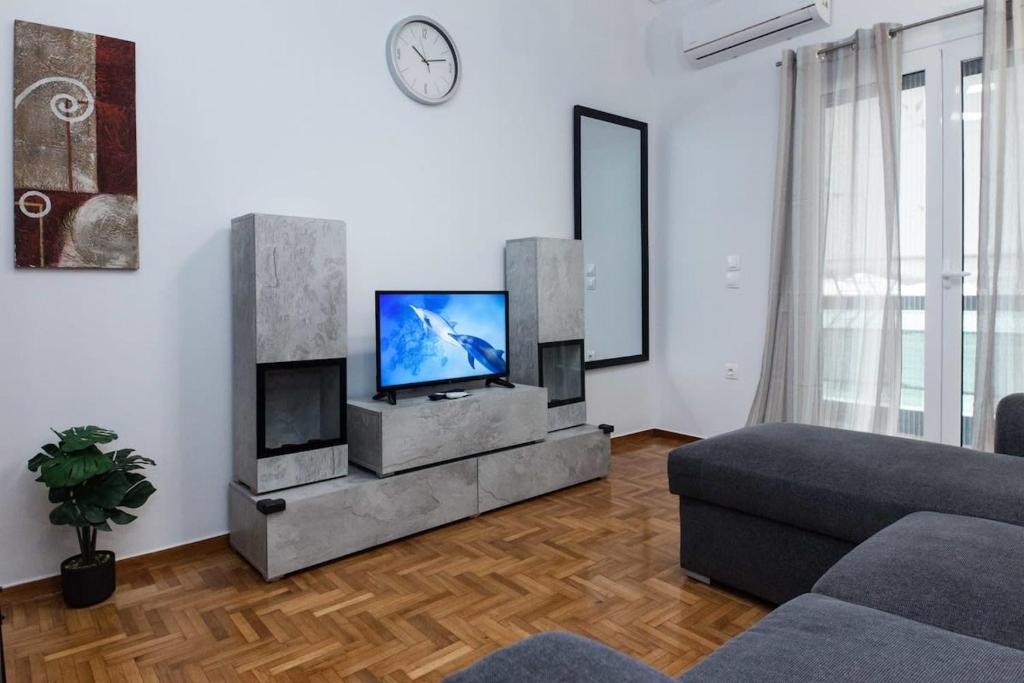 a living room with a tv and a couch at Modern Cozy 1 Bd Piraeus Perfection Apt in Piraeus