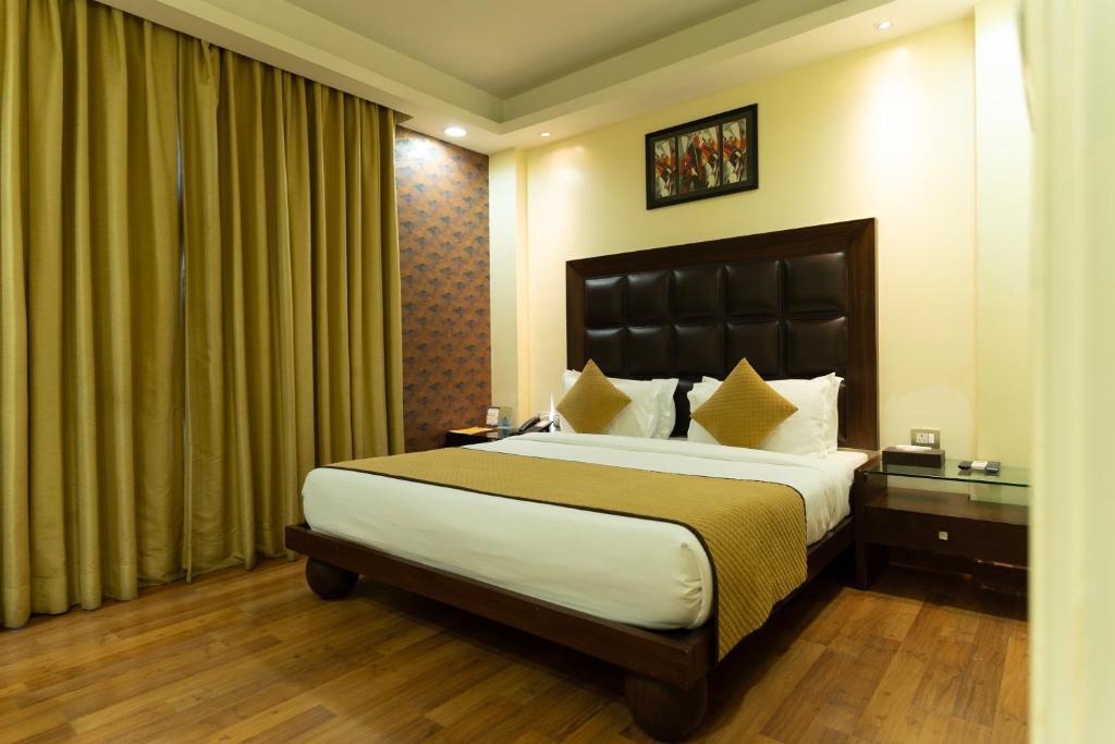 a bedroom with a large bed in a room at The Grand Orion - Kailash Colony in New Delhi