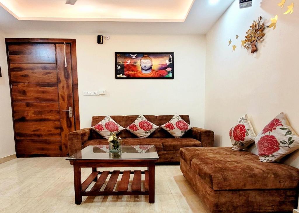 a living room with a couch and a table at Yogvan Luxury 1BHK Apartments Tapovan Rishikesh in Rishīkesh