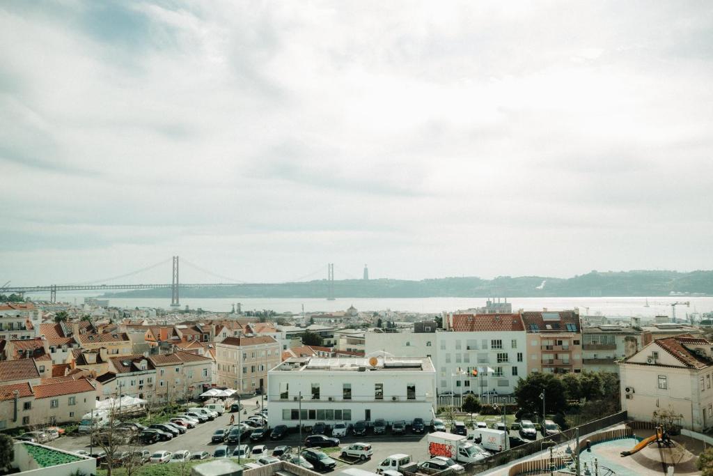 a view of a city with a bridge in the background at Belém Tejo - Memória by Local in Lisbon