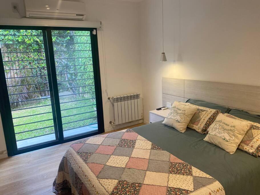 a bedroom with a bed and two large windows at Acogedora casa en Santo Tome in Santo Tomé