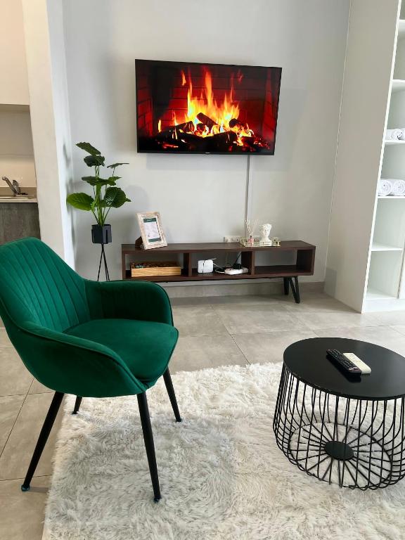 a living room with a green chair and a fireplace at White Oasis in Gaborone