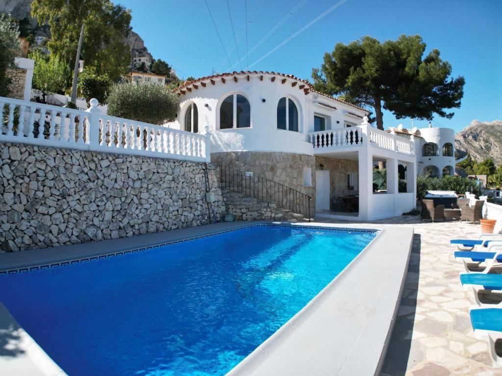 a villa with a swimming pool and a house at Villa Marisol in Calpe