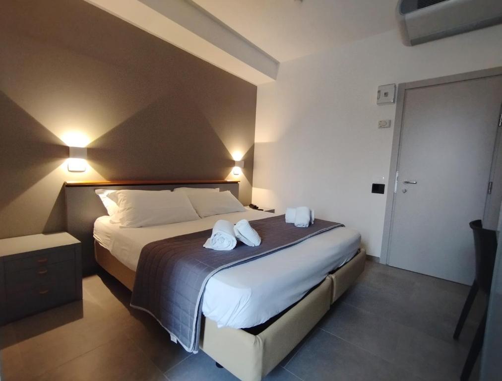 Posteľ alebo postele v izbe v ubytovaní Hotel Excelsior
