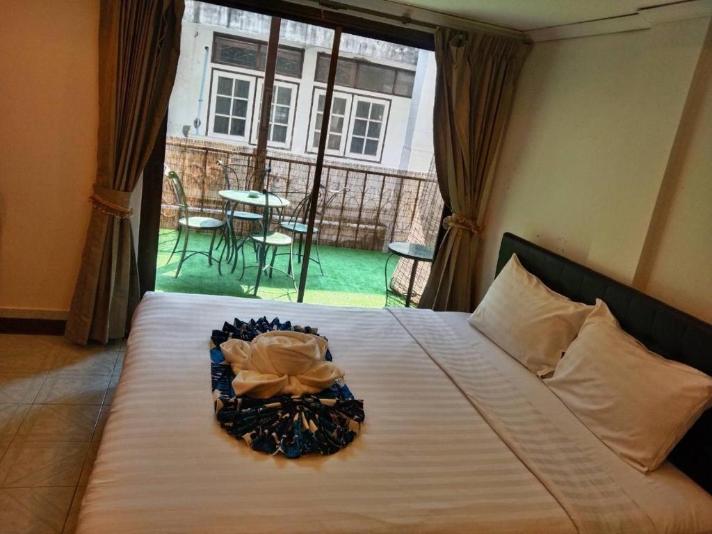 a bedroom with a bed with a view of a patio at the L Hua Hin in Hua Hin