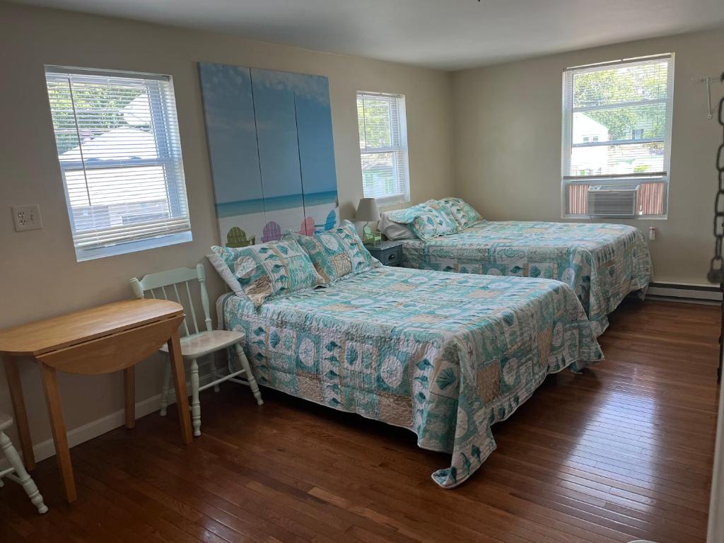 a bedroom with a bed and a couch and a table at Pine View Lodge Old Orchard Beach in Old Orchard Beach
