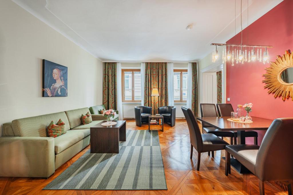 a living room with a couch and a table at Serviced-Appartements-Josefstadt in Vienna