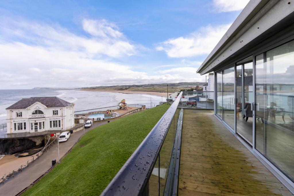 uma vista para o oceano a partir da varanda de um edifício em 55 North Apartments Portrush em Portrush