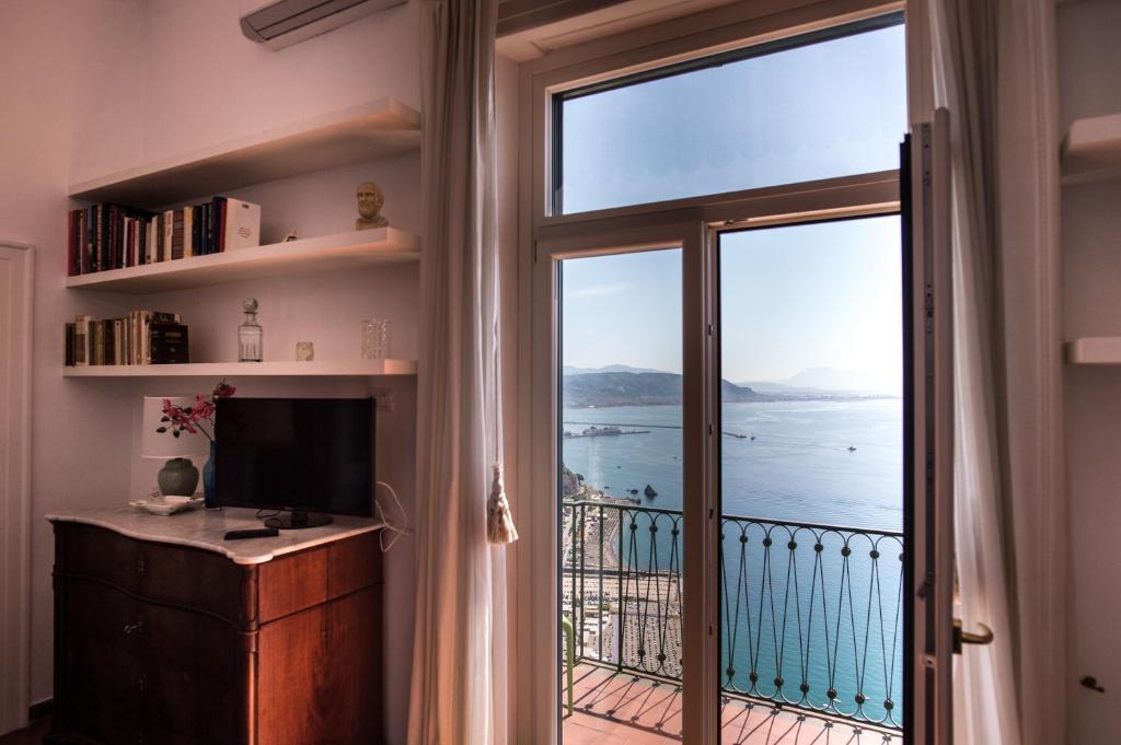 a room with a large window with a view of the ocean at Beatrice Luxury Apartment in Vietri